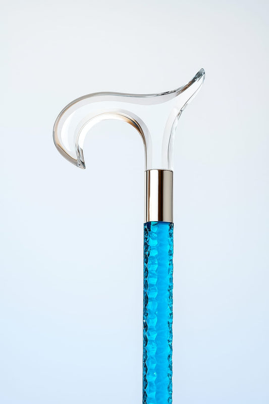Blue glass cane with silver top on a light gray background